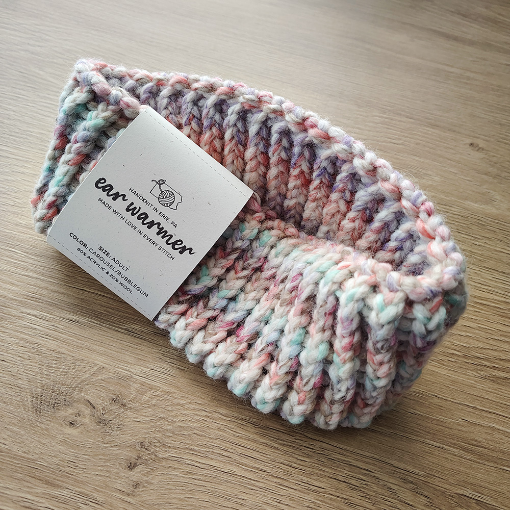 Carousel-Bubblegum-colored Ear Warmer on Table